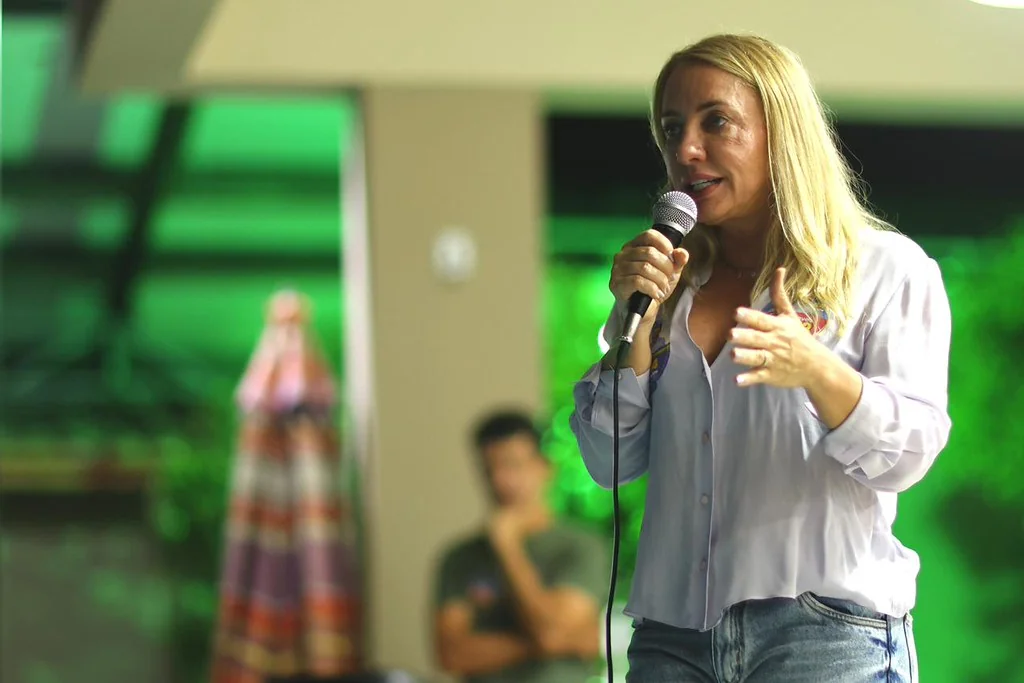 Ieda Chaves discursando com microfone em evento de campanha